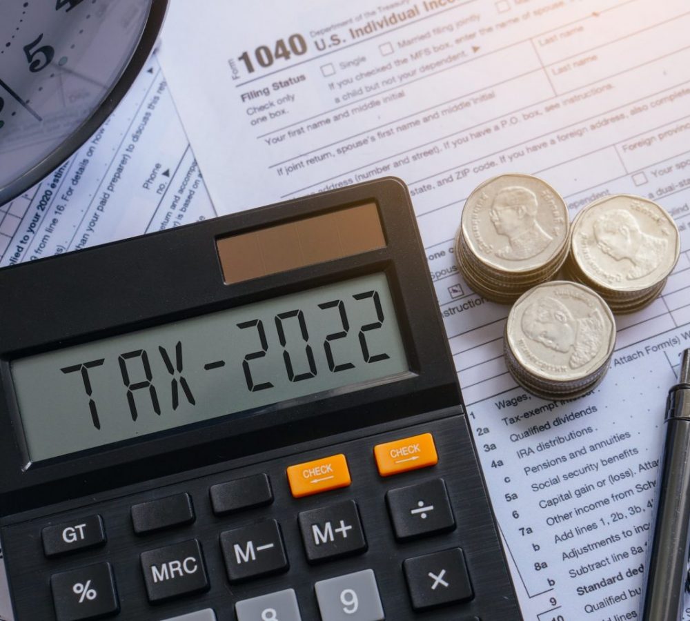 Tax word and 2022 number on calculator. Pay tax or vat in 2022 years. Business and tax concept.